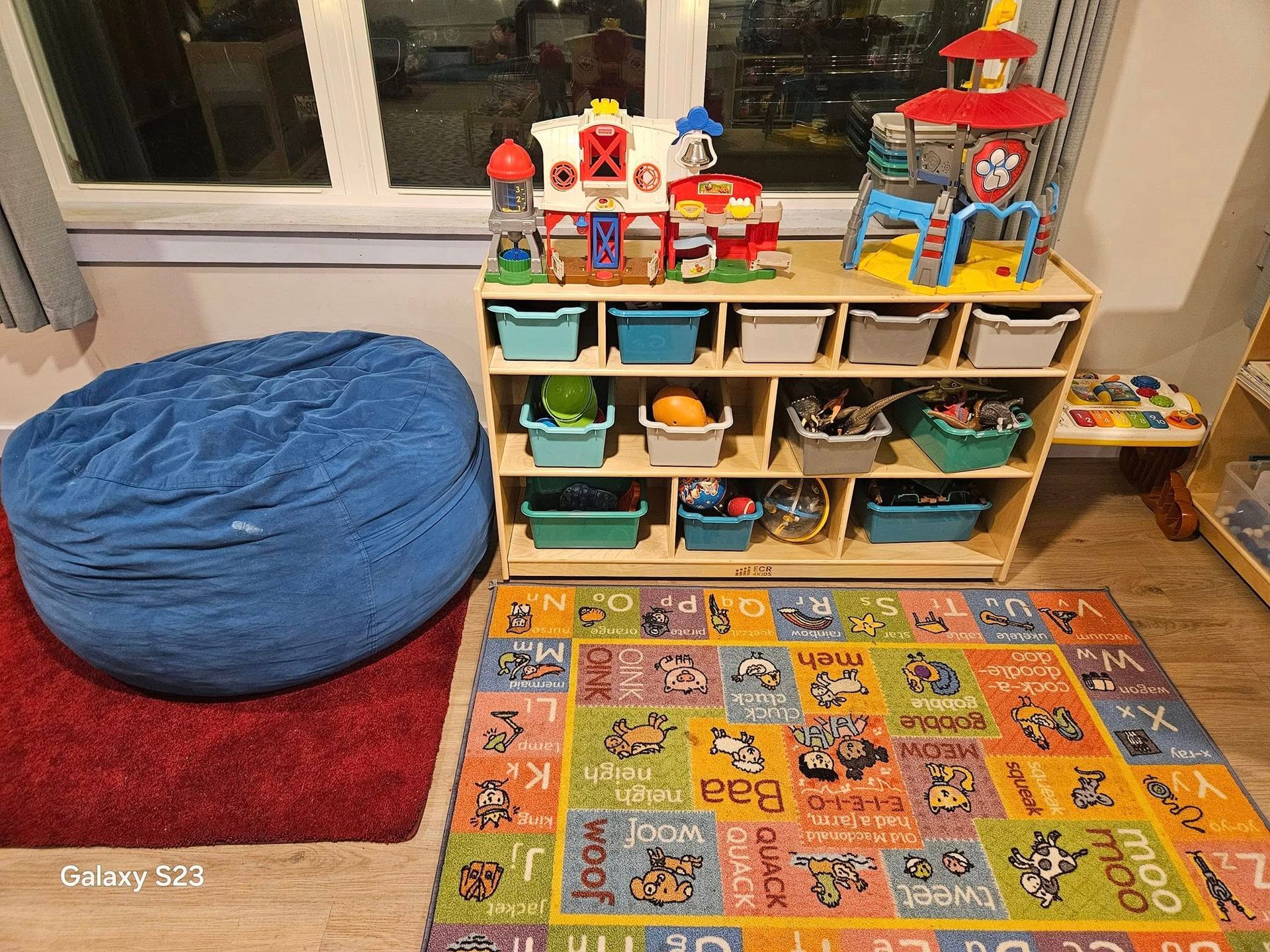 A room filled with lots of toys and a bean bag chair.